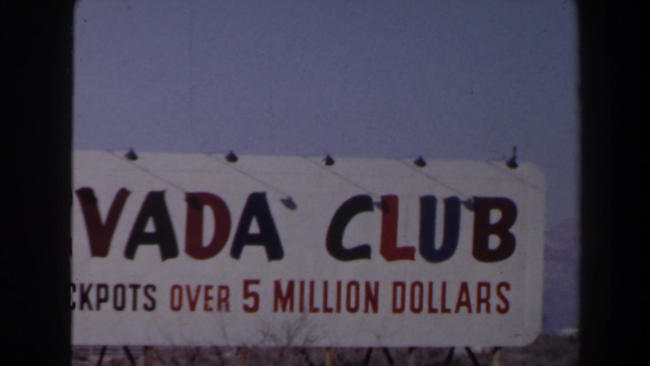Cropped 1958 Las Vegas view of the Nevada Club sign, with the jackpot line visible beneath large lettering.