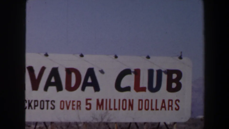 Cropped 1958 Las Vegas view of the Nevada Club sign, with the jackpot line visible beneath large lettering.