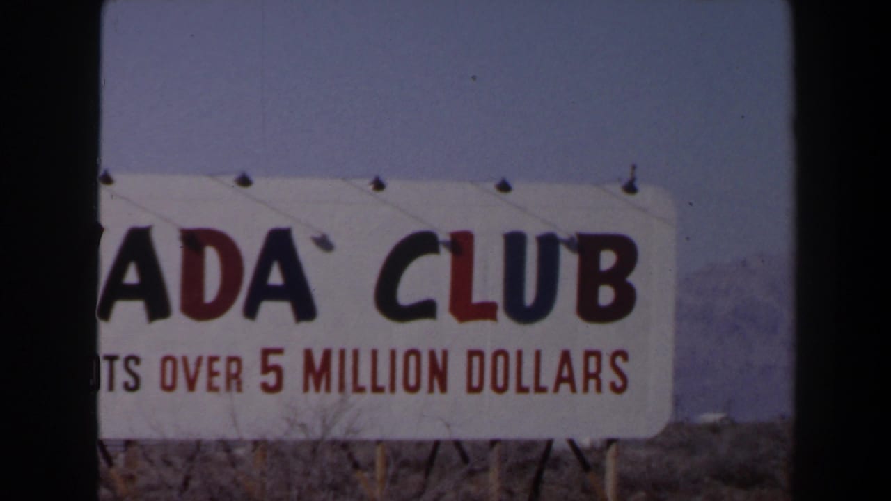 Final 1958 Las Vegas frame showing the Nevada Club sign cropped across the left edge, with jackpot advertising visible.