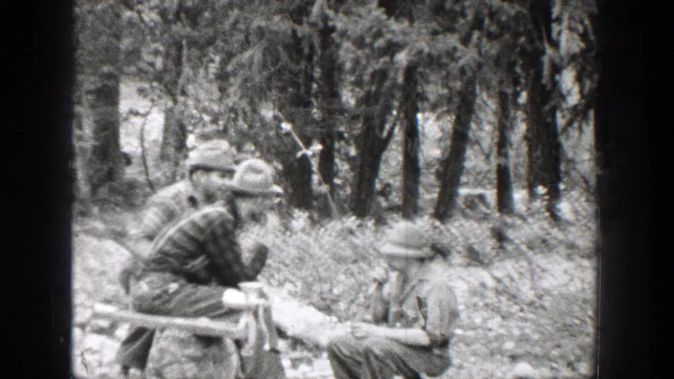 Several men in hats are grouped among trees in the Chelan, Washington footage, with one seated or crouched near the foreground.