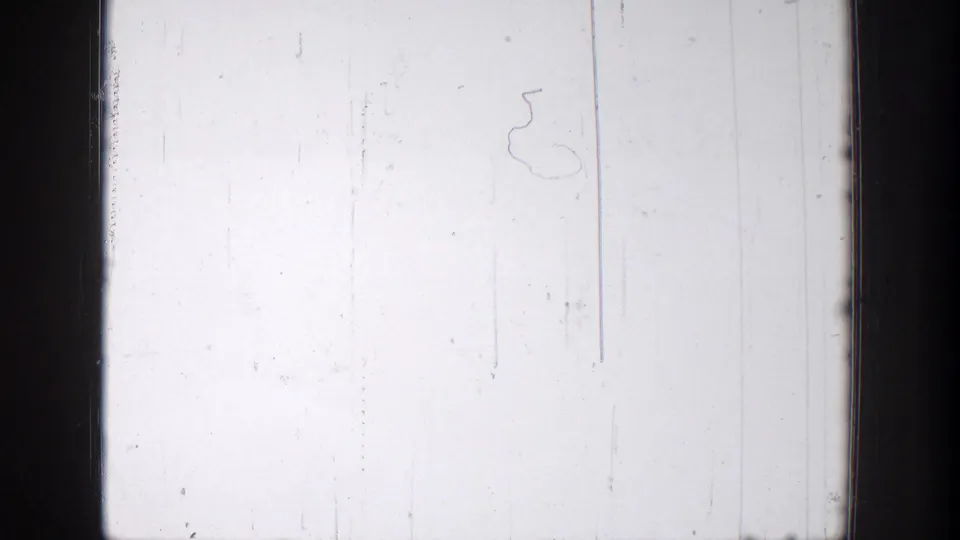 Overexposed 8mm frame from the 1939 Chelan clip, showing pale sky or blank exposure with scratches and dark film borders.