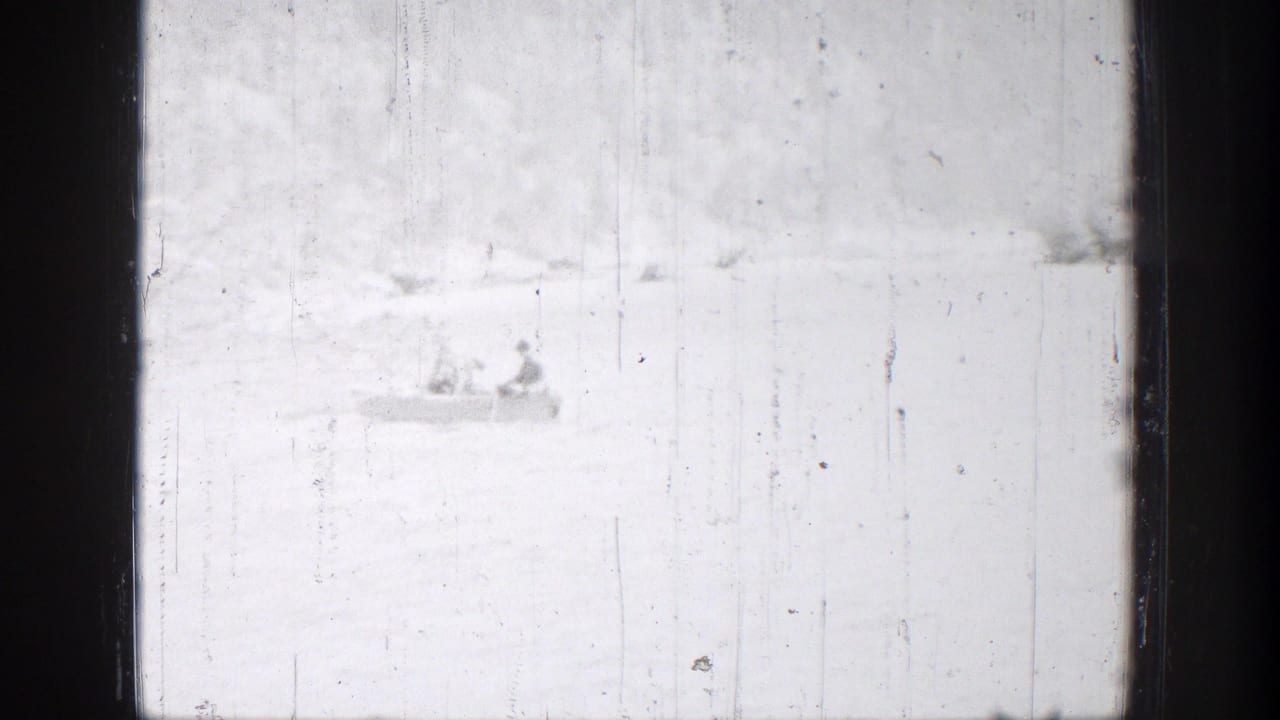 Distant rowboat with two people on bright water in Chelan, Washington, seen through washed 8mm exposure.
