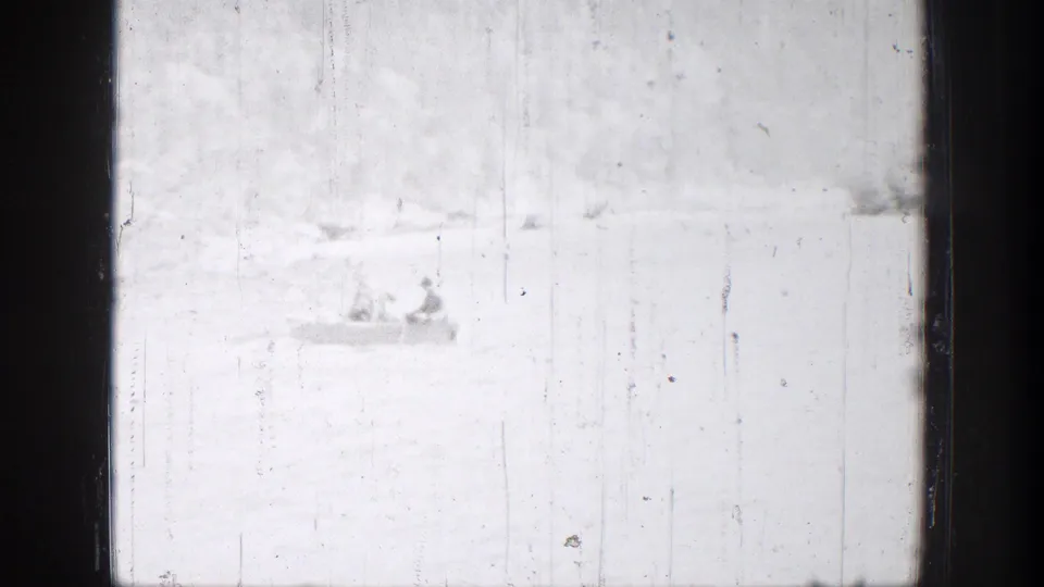 Distant rowboat with two people on bright water in Chelan, Washington, seen through washed 8mm exposure.