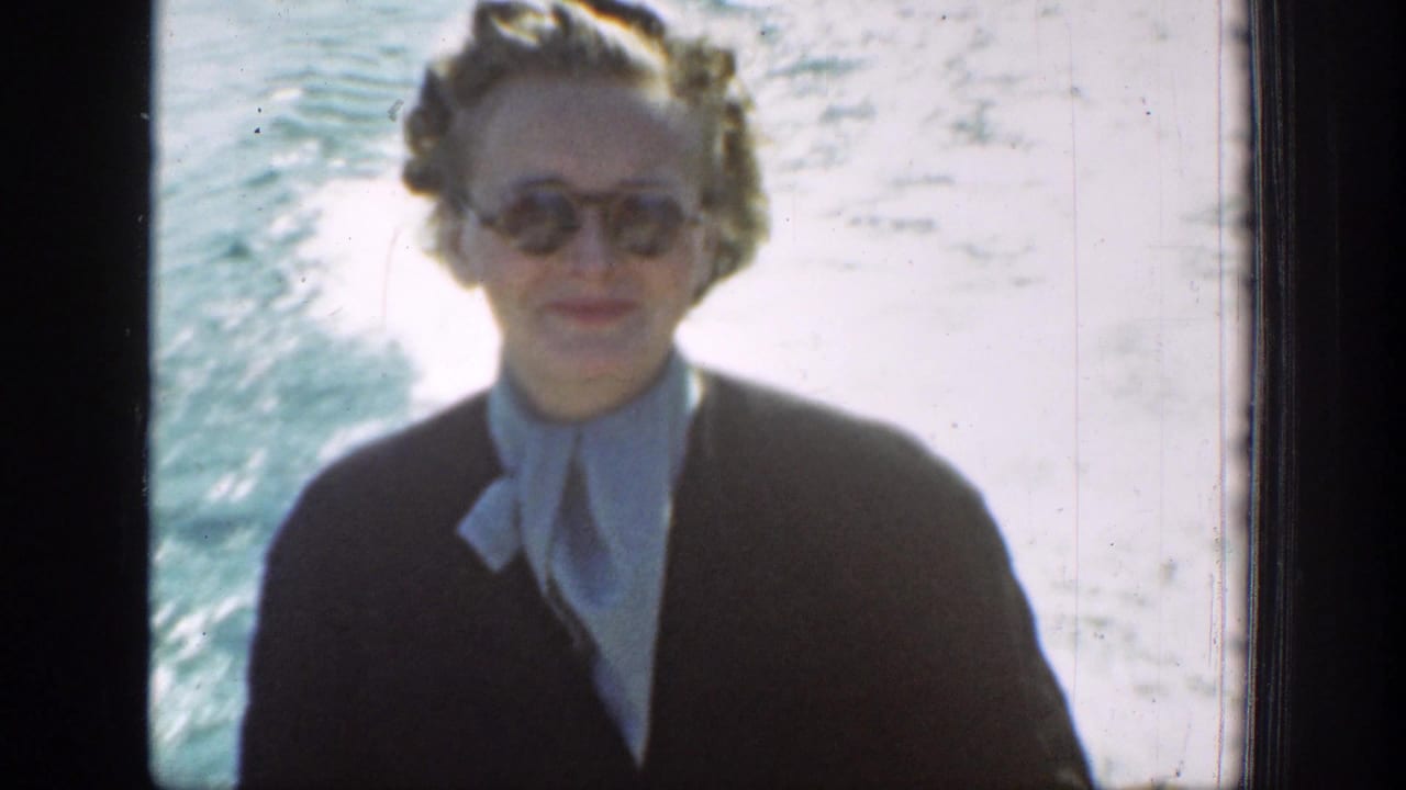 Close home-movie view of a woman passenger in sunglasses on a 1939 Chelan lake boat ride.