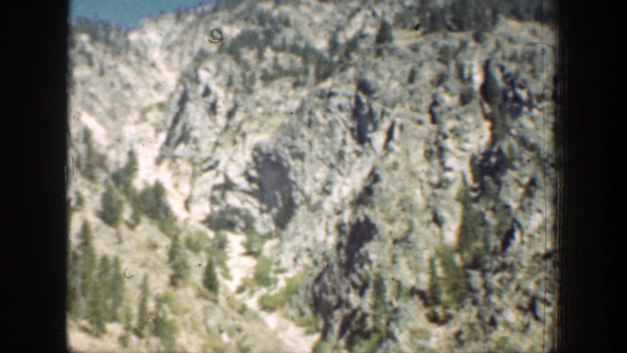 1939 Chelan, Washington mountain terrain with steep exposed rock and pines along the lower slope.