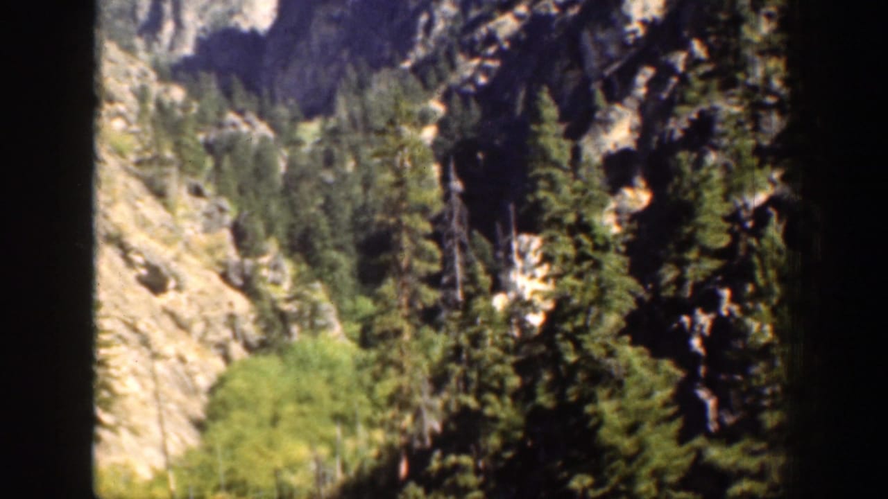 1939 Chelan-area 8mm frame showing a steep rocky valley lined with evergreen trees.