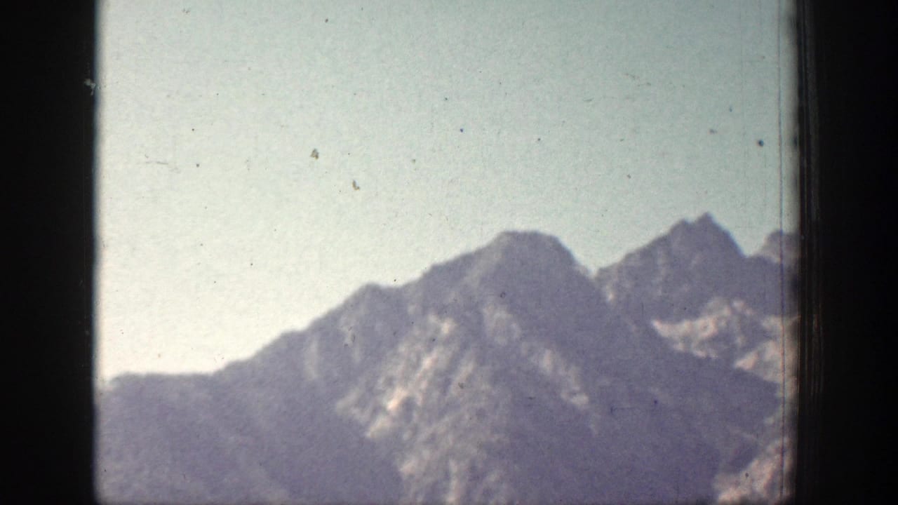 1939 Chelan, Washington 8mm view of hazy mountain ridges, softened by exposure, grain, and distance.