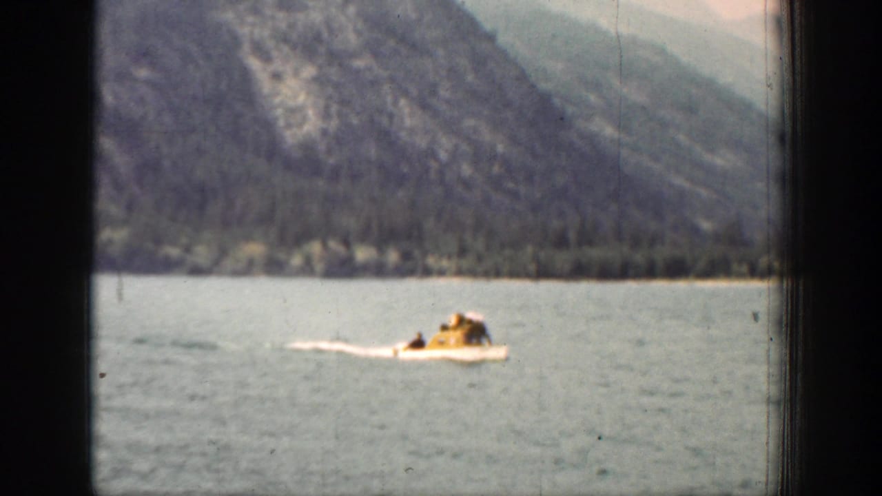 The boat appears closer in the 1939 Chelan footage, with a rider in yellow visible against the lake and mountain shoreline.