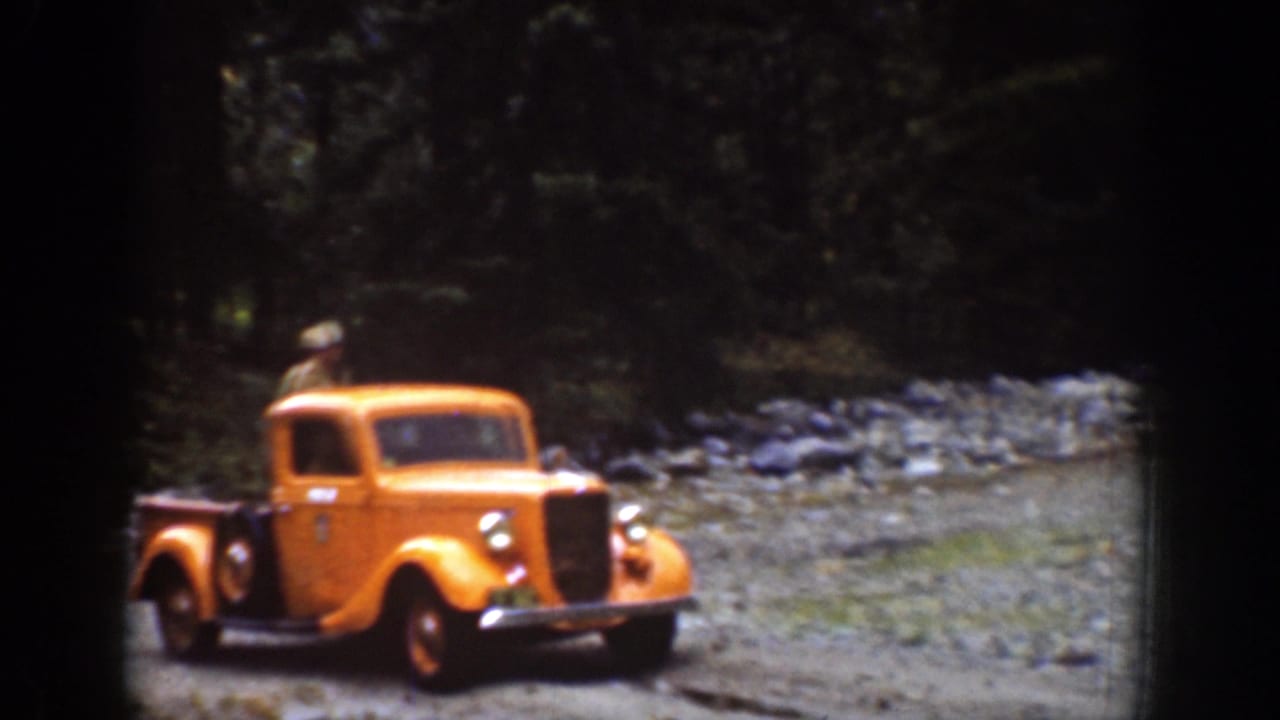 Yellow vintage pickup traveling on a rugged forest road in the 1939 Chelan, Washington footage.