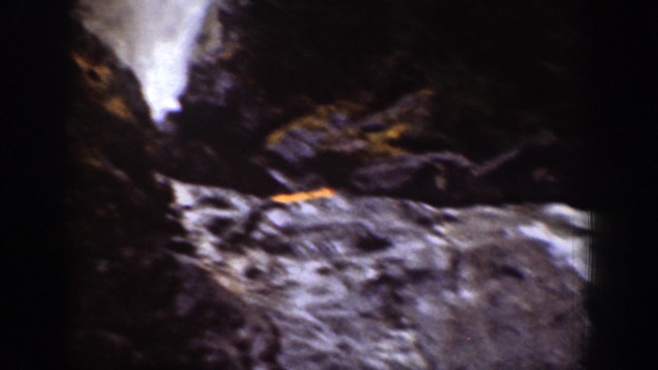 Home-movie view of a waterfall and rocky streambed in a shadowed Chelan, Washington ravine, filmed on 8mm in 1939.