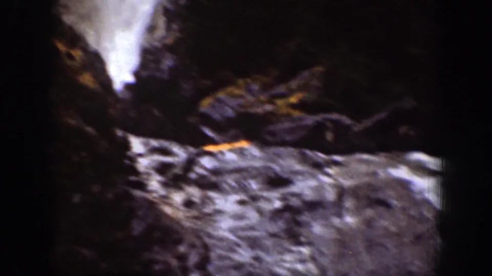 Home-movie view of a waterfall and rocky streambed in a shadowed Chelan, Washington ravine, filmed on 8mm in 1939.