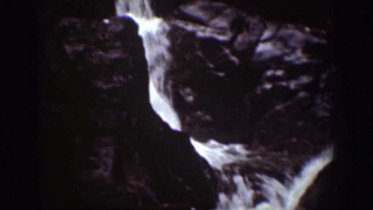 Chelan, Washington 8mm frame showing water dropping through dark rock formations into a lower churning cascade.