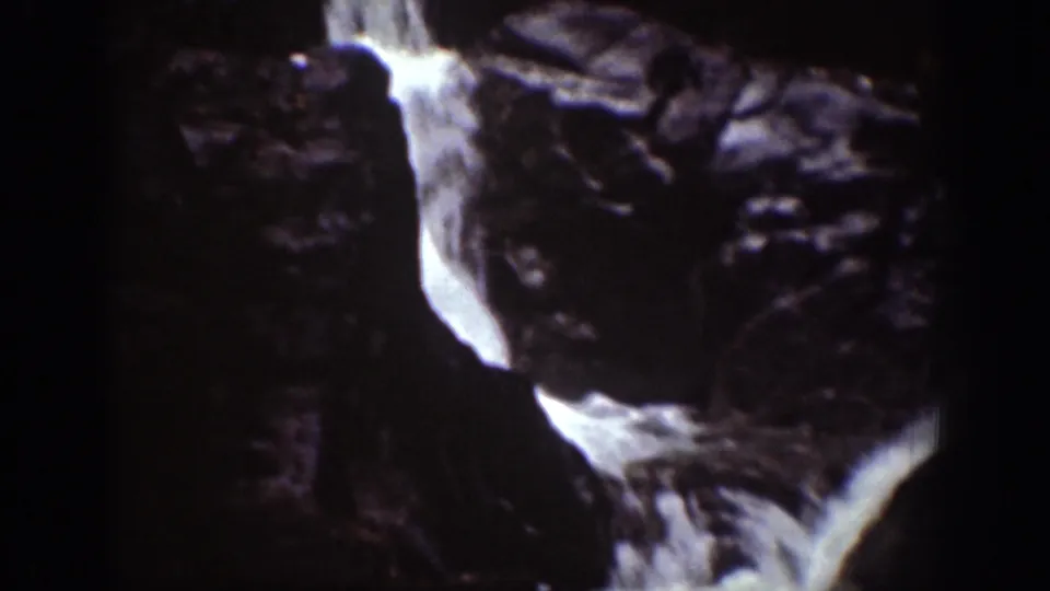 Chelan, Washington 8mm frame showing water dropping through dark rock formations into a lower churning cascade.