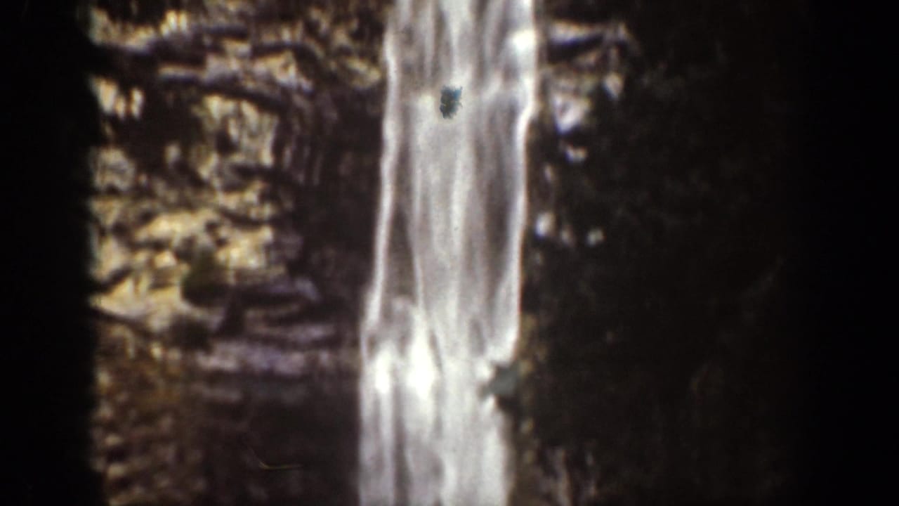 Vertical waterfall segment beside layered rock, from the 1939 Chelan, Washington home-movie footage.