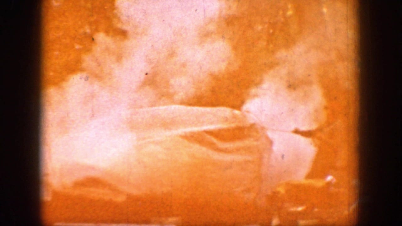 1939 Chelan, Washington frame with a tent or tarp nearly washed out by bright exposure and smoke-like haze.