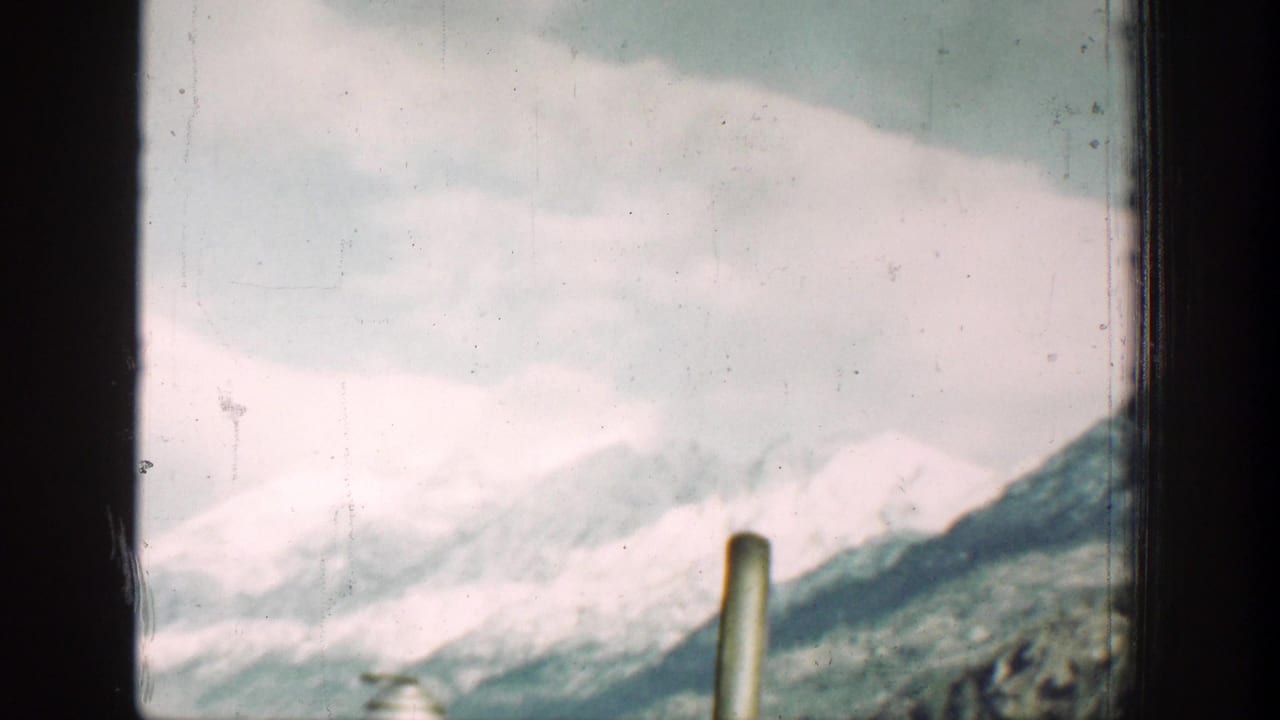 The final frame shows Chelan-area snow-covered mountains and valley slopes through a vehicle window.