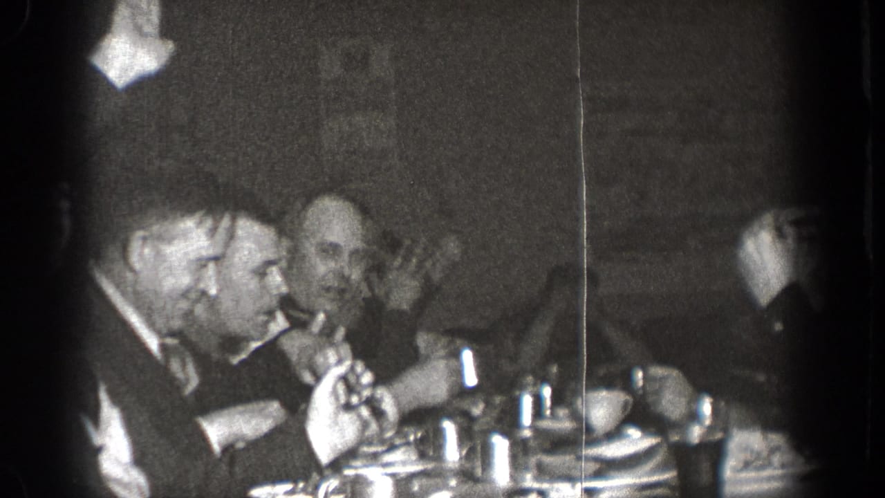 A 1939 Chelan dinner scene shows suited men in animated conversation with tableware and drinks in front of them.
