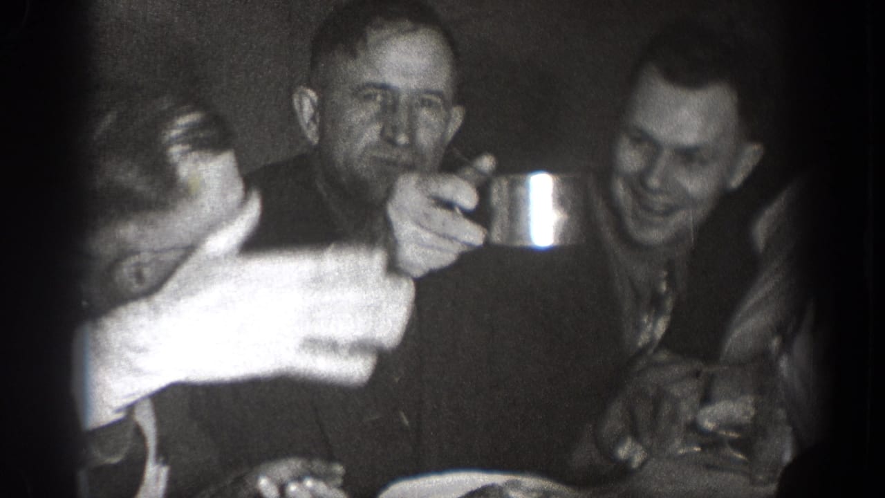 In the final frame, men sit around the Chelan table with plates and cups, including one man holding a metal cup toward the camera side.