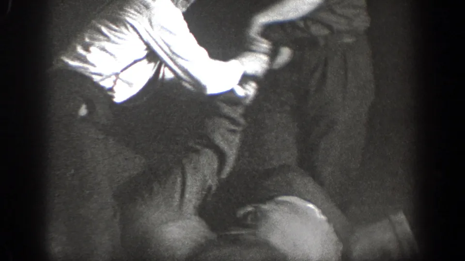 Chelan, Washington 1939 home-movie frame showing adults in a low floor hold during martial arts practice.