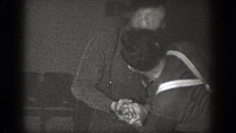 In 1939 Chelan, Washington home-movie footage, two adult men appear to grapple or restrain each other in a dim indoor setting.