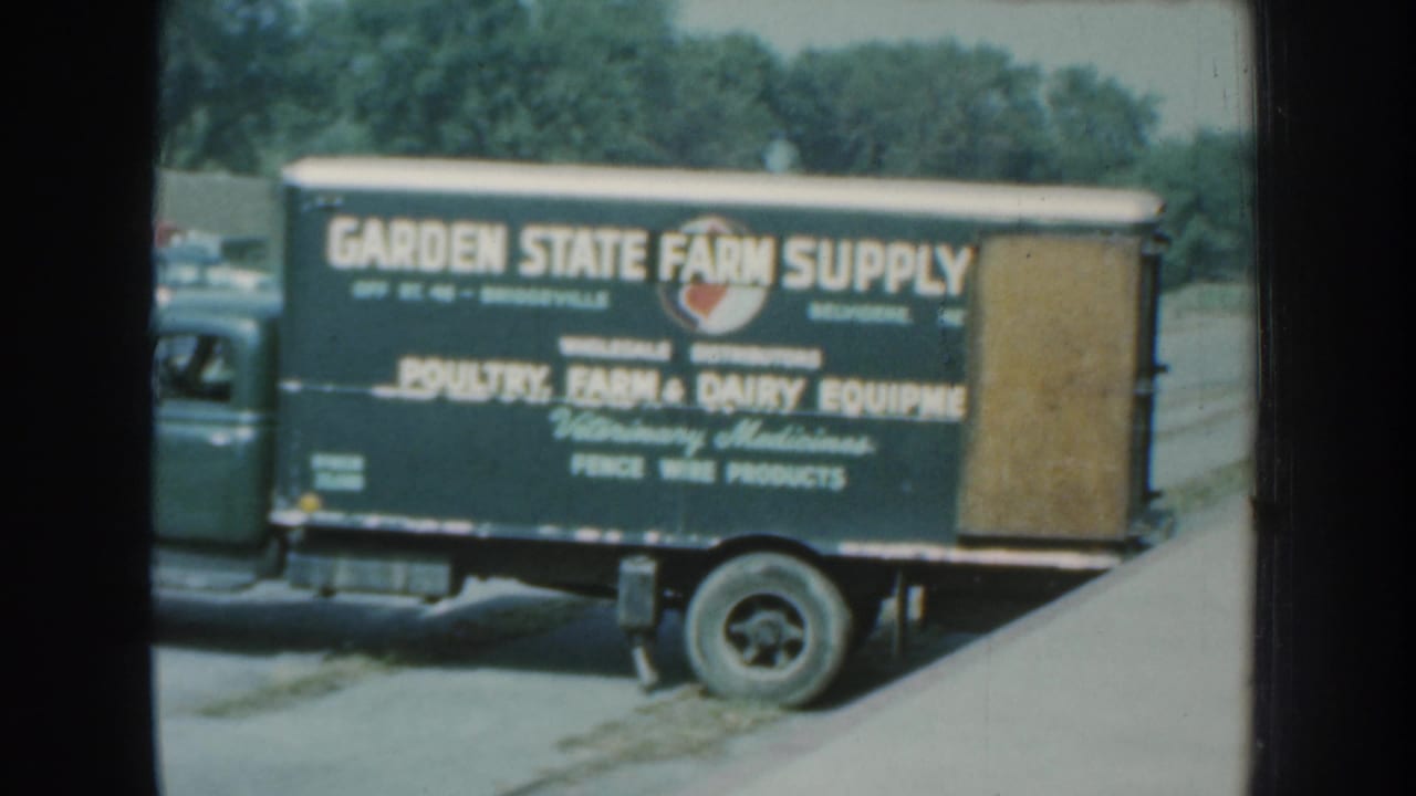 Garden State Farm Supply truck parked beside a rural building area.