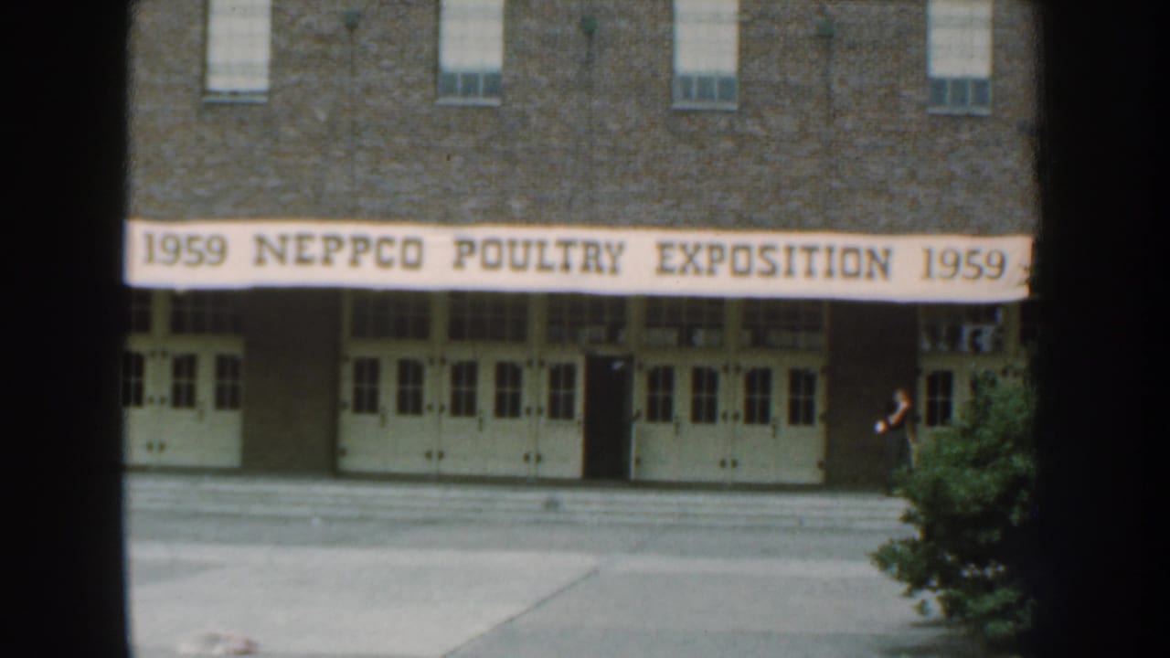 Brick building entrance with a banner reading 1959 NEPPCO Poultry Exposition.