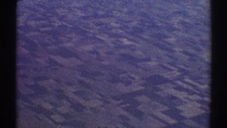 Faded 8mm frame showing an indistinct aerial landscape, likely filmed from an airplane over the Los Angeles area in 1969.