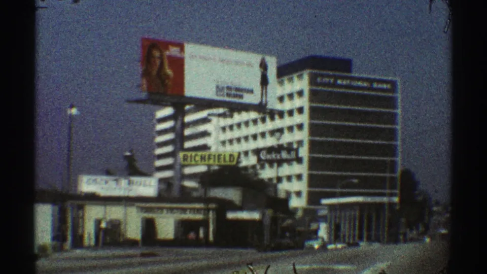 1969 Los Angeles commercial street view with visible Richfield signage, Cock n Bull sign, billboard, and a striped office building.