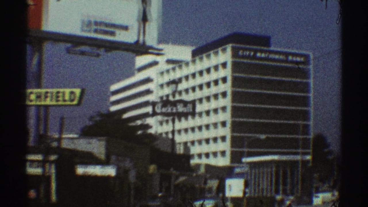 1969 Los Angeles street view approaching a City National Bank building, with a Richfield sign and billboard structures visible.