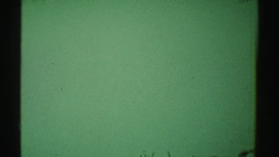 Green-tinted 8mm frame from the 1969 Los Angeles reel, showing a mostly empty interior surface with dark edges.