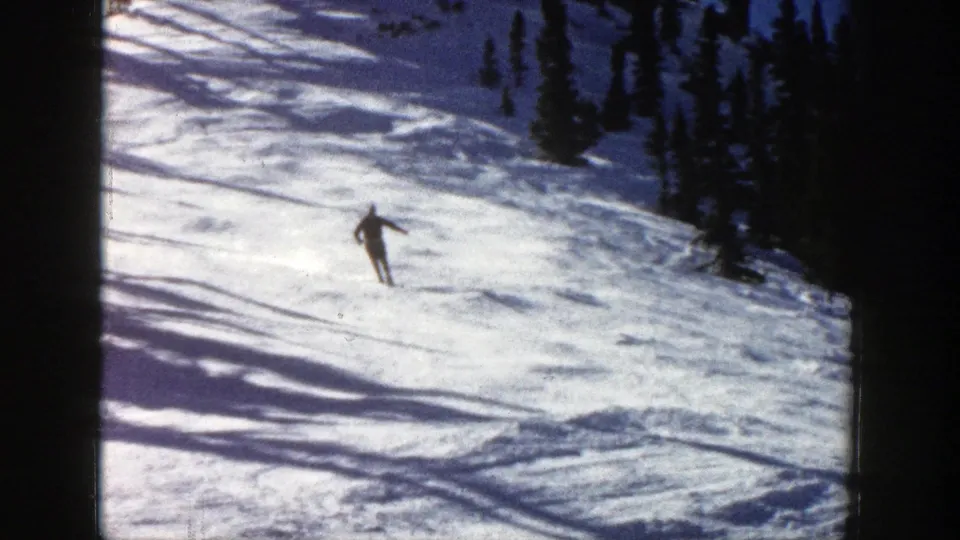 Near the end of the clip, the skier continues downhill on the Aspen slope, framed by snow, shadows, and evergreens.