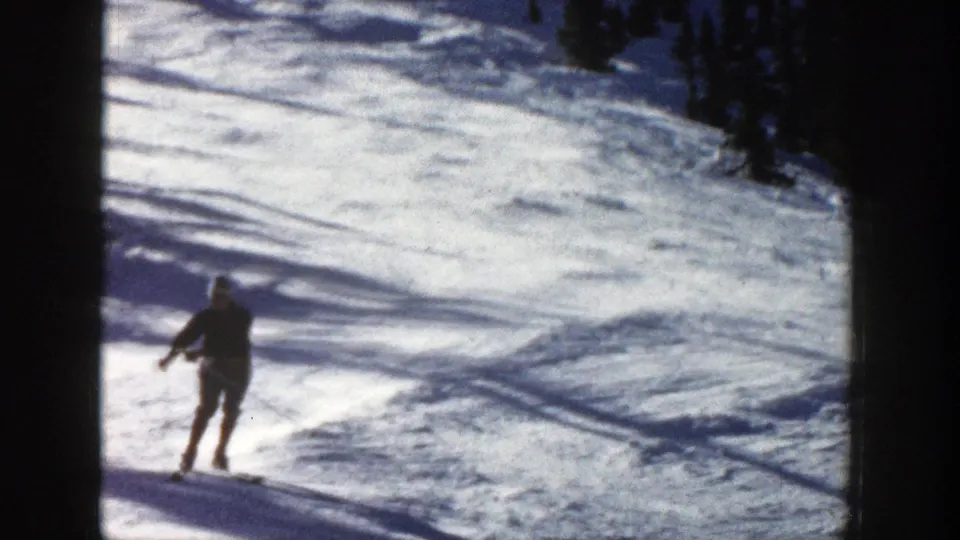 Near the end of the clip, the skier passes close to the camera on the snowy Aspen slope, with pine trees still visible above.
