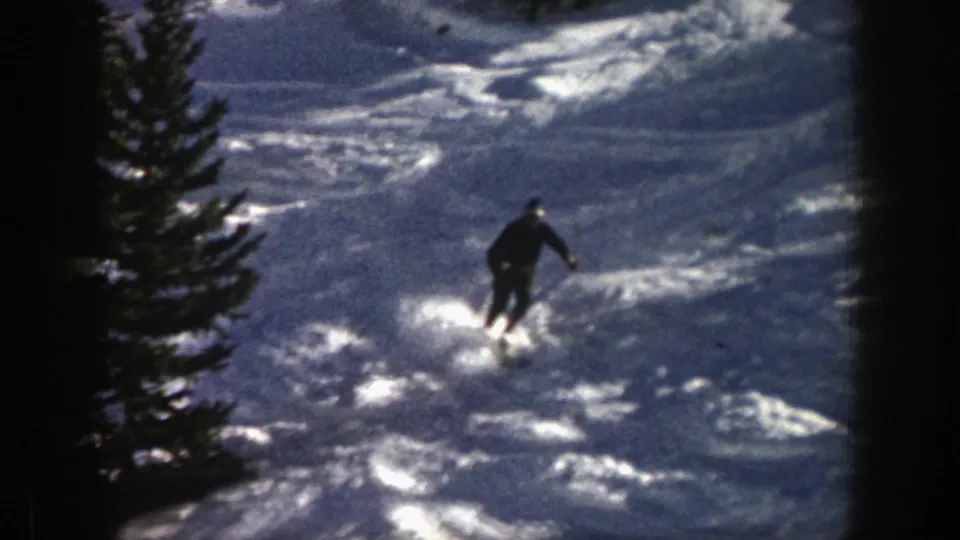 Near the end of the clip, the skier moves farther downhill through a bright, forested Aspen snowfield.