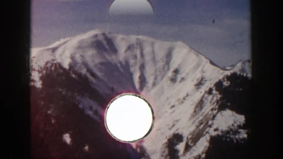Aspen, Colorado 8mm frame of the snowy mountain with visible film edge or perforation artifact over the lower part of the frame.