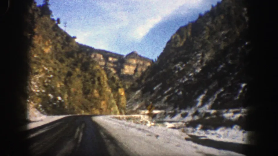 The final frame looks down a winter mountain road near Aspen, with snowbanks, dark pavement, rocky slopes, and bright sky visible from the car.