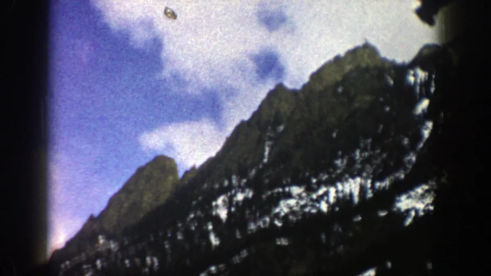 1961 Aspen-area 8mm close view of rugged snow-streaked peaks under a brighter blue sky.