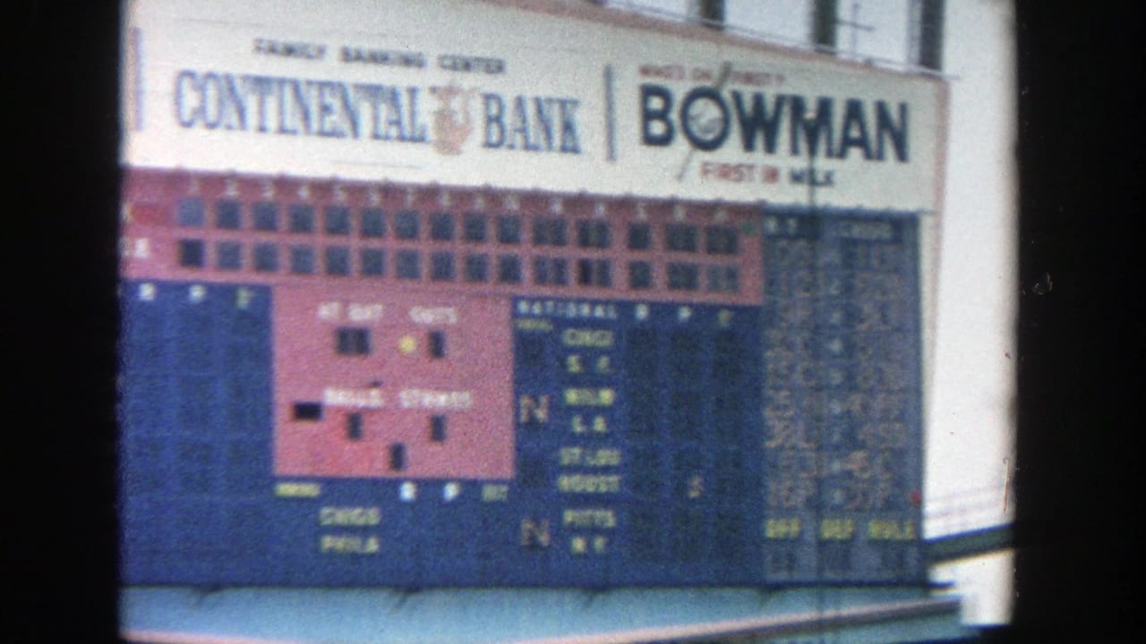 The Yankee Stadium scoreboard fills the frame, showing team-score columns, Continental Bank signage, Bowman advertising, and stadium railings.