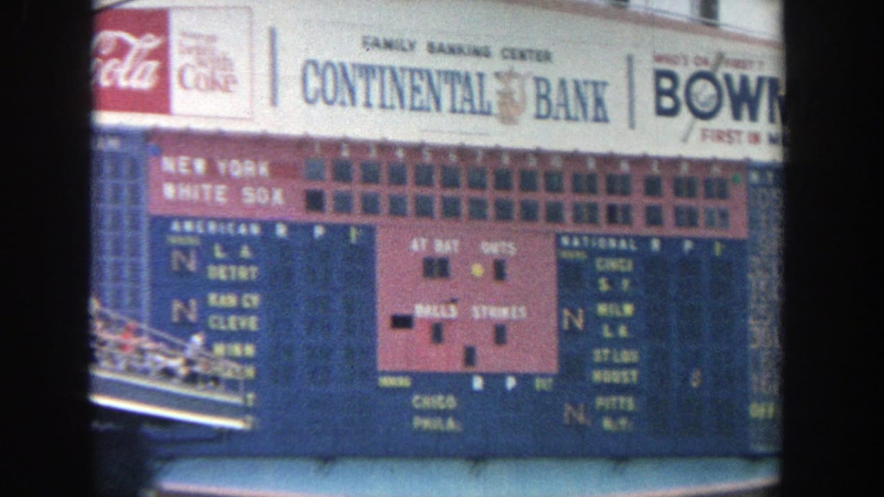A clearer scoreboard view shows Coca-Cola, Continental Bank, and Bowman signage above team and score panels at Yankee Stadium.