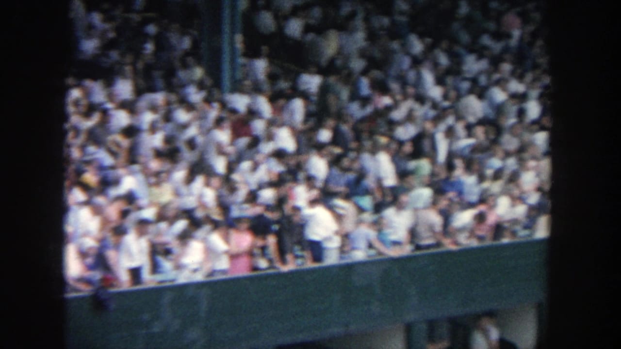 1964 Yankee Stadium home-movie view of crowded bleachers and green stadium structure from the stands.