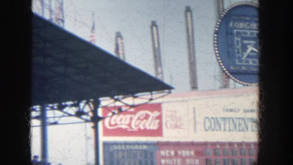 1964 Yankee Stadium scoreboard detail with Longines clock partly at right and Coca-Cola and Continental Bank signage below.