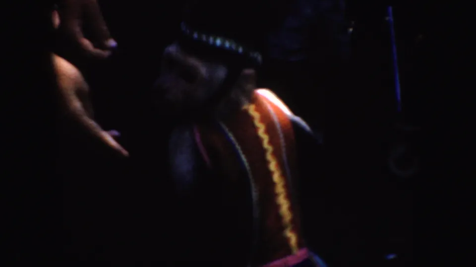 A shadowy costumed figure appears in the 1952 California footage, with a red panel and yellow zigzag trim visible.