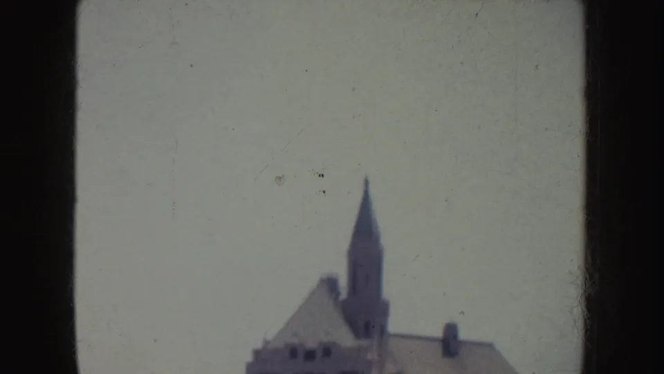 Final 1952 California frame with the building cropped low, leaving a pointed tower and roofline against open sky.