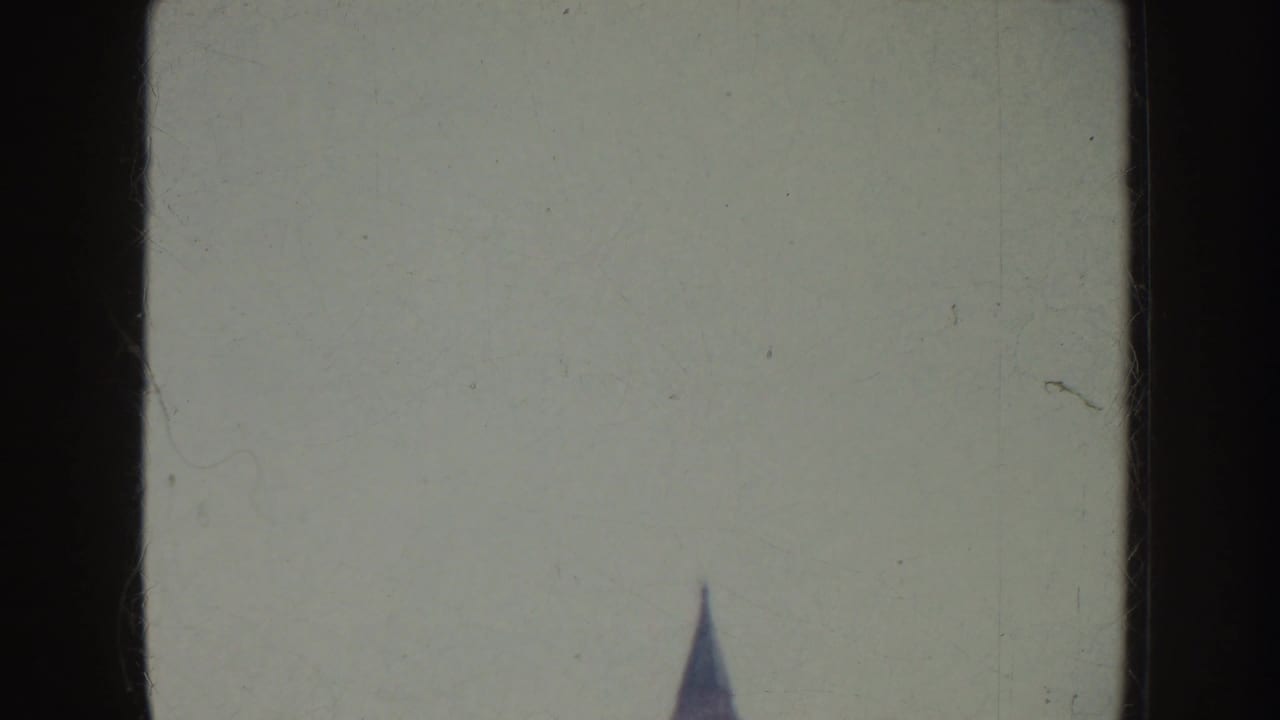 Soft 8mm frame with a pale exposed area and a partial street-side view at the edge of the California sidewalk scene.