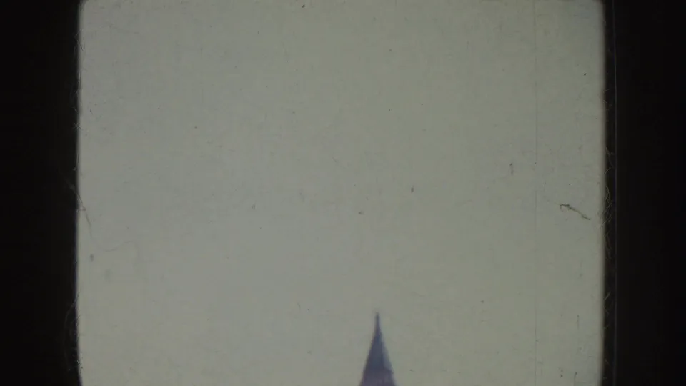 Soft 8mm frame with a pale exposed area and a partial street-side view at the edge of the California sidewalk scene.