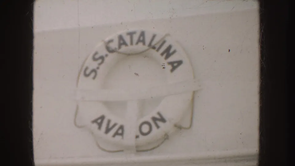 1952 California 8mm frame showing a white S.S. Catalina life preserver with partial Avalon lettering and soft film texture.