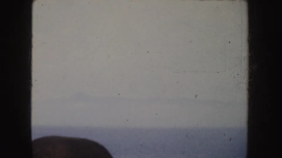 Faded 1952 California 8mm ocean view with a pale horizon and an indistinct dark foreground shape near the lower left.