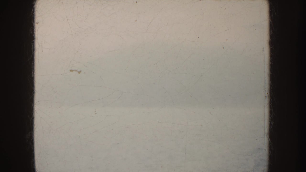 Fog-obscured water and faint horizon within dark 8mm frame edges.