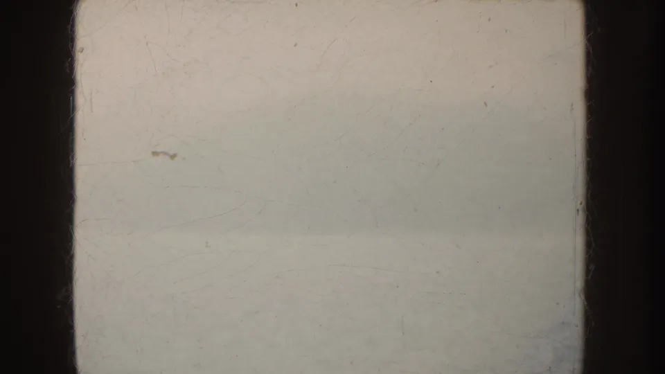 1952 California 8mm frame with foggy water, a faint distant horizon, pale exposure, dust, and dark film borders.