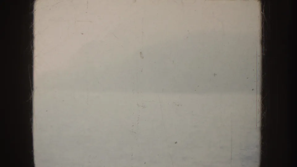 1952 California 8mm frame showing a hazy water view with muted tones, faint background forms, and worn film texture.