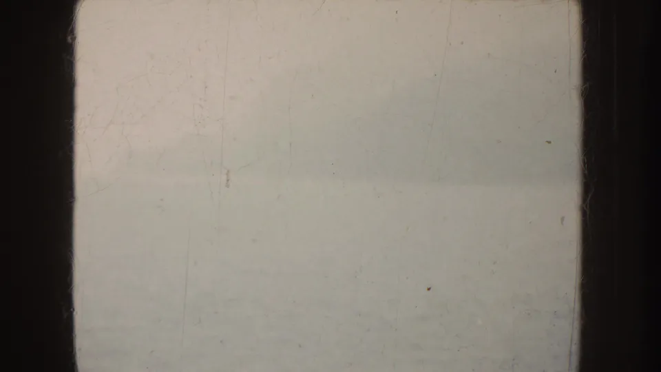 1952 California 8mm frame with fog, a soft waterline, subdued color, scratches, dust, and visible gate edges.